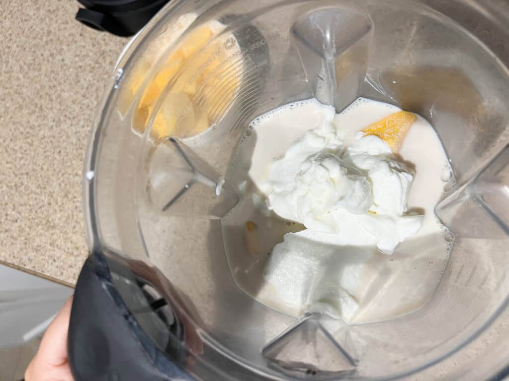 greek yogurt added to mango chia pudding mixture