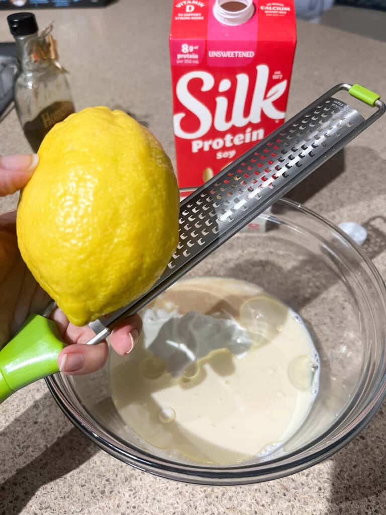 lemon and zester over clear mixing bowl