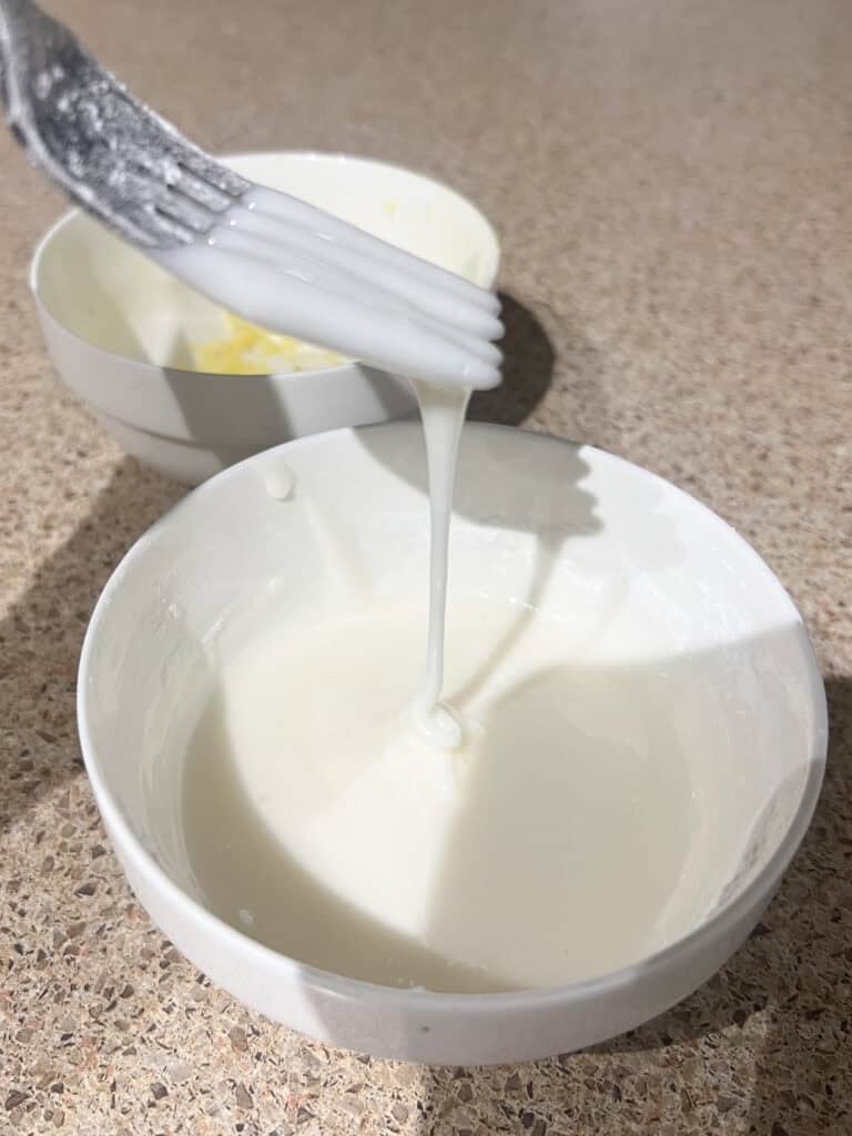 lemon icing for lemon loaf in white bowl