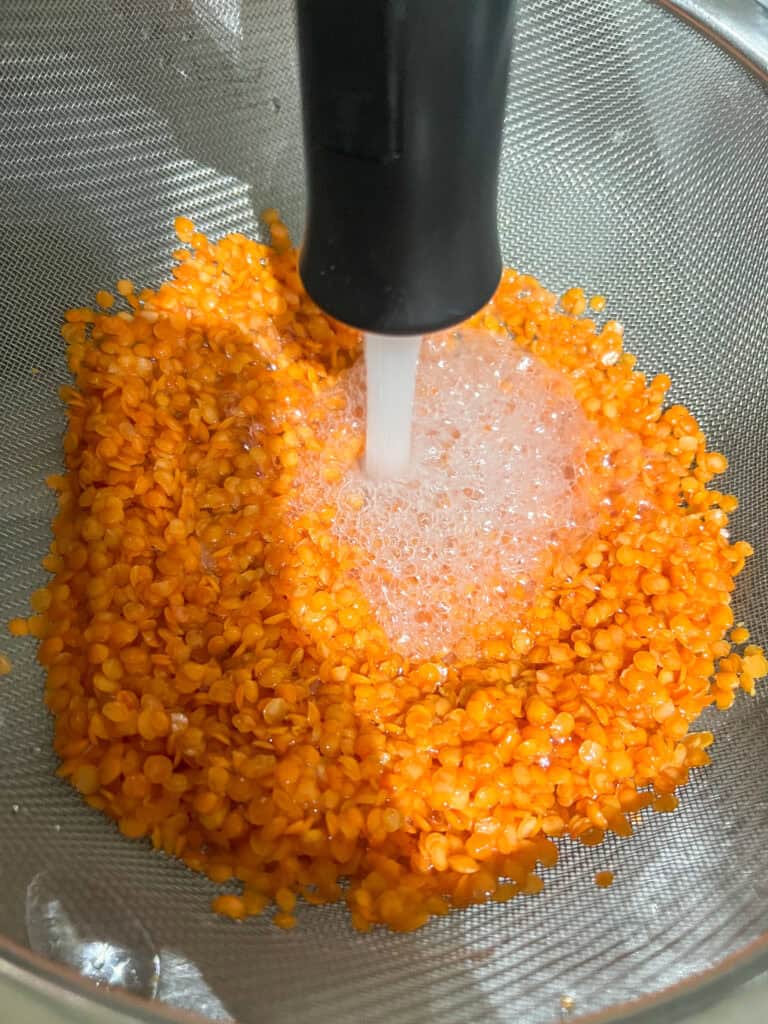 red lentils being rinsed