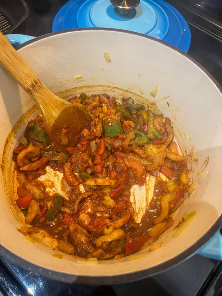 cooking peppers and spices in dutch oven