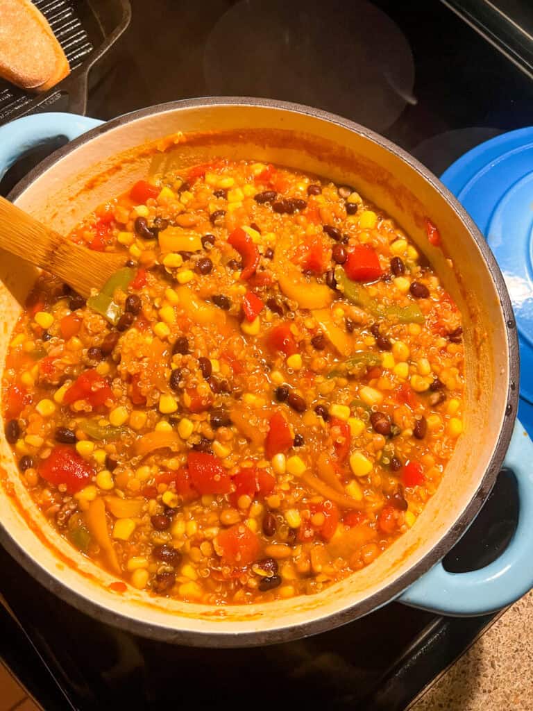 red lentil quinoa veg chili in dutch oven pot