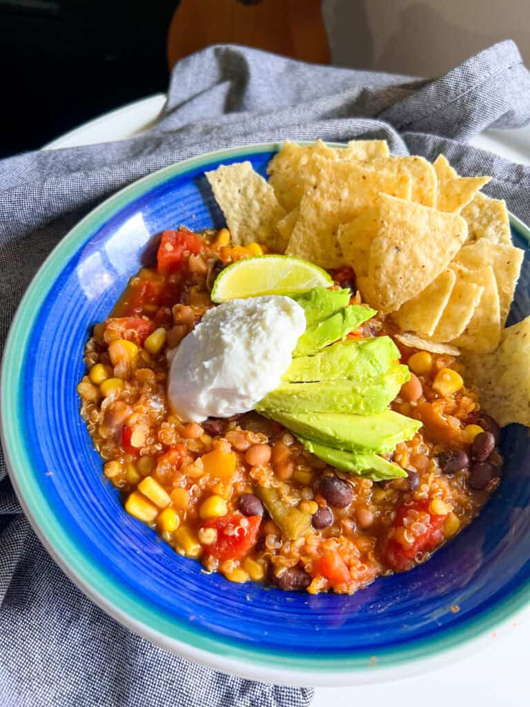 red lentil quinoa chili vegan with avocado sour cream tortilla chips