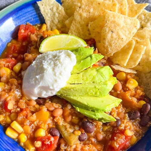 red lentil quinoa chili vegan with avocado sour cream tortilla chips