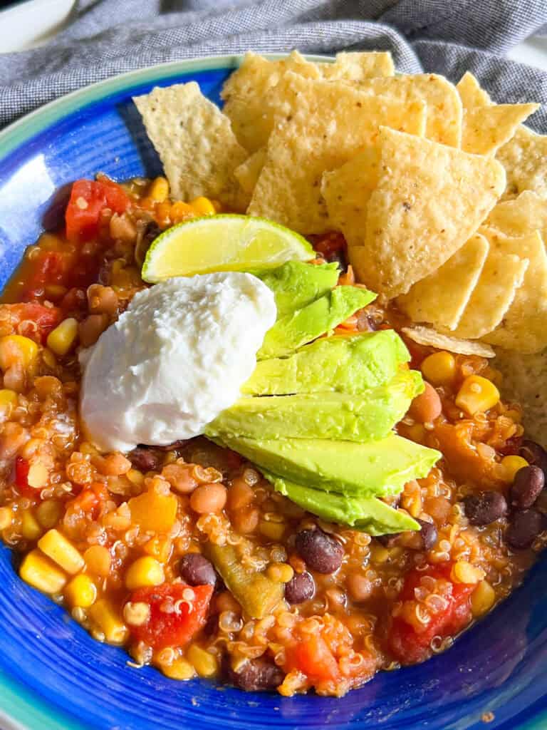 red lentil quinoa chili vegan with avocado sour cream tortilla chips