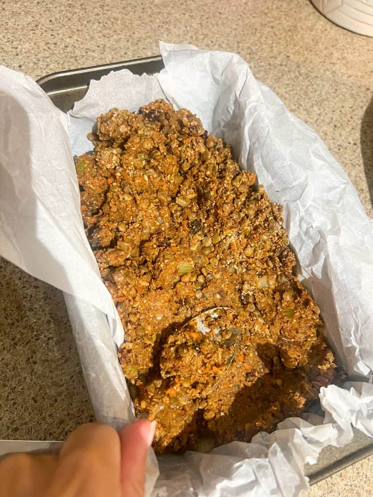 lentil loaf mixture in pan and parchment paper