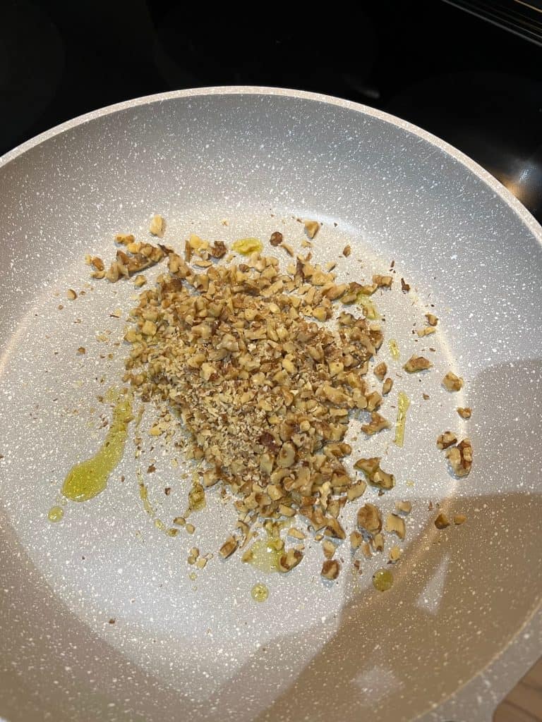 walnuts and oil in pan