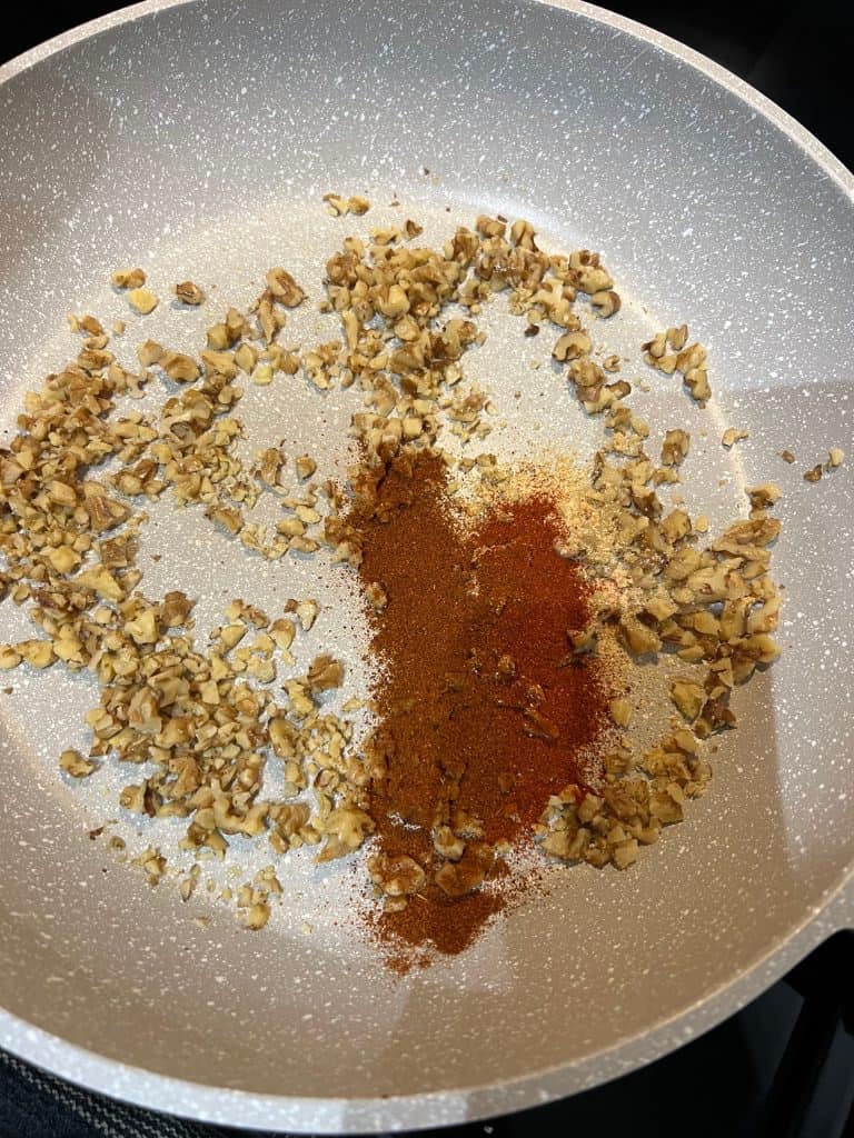 walnuts and spices in pan