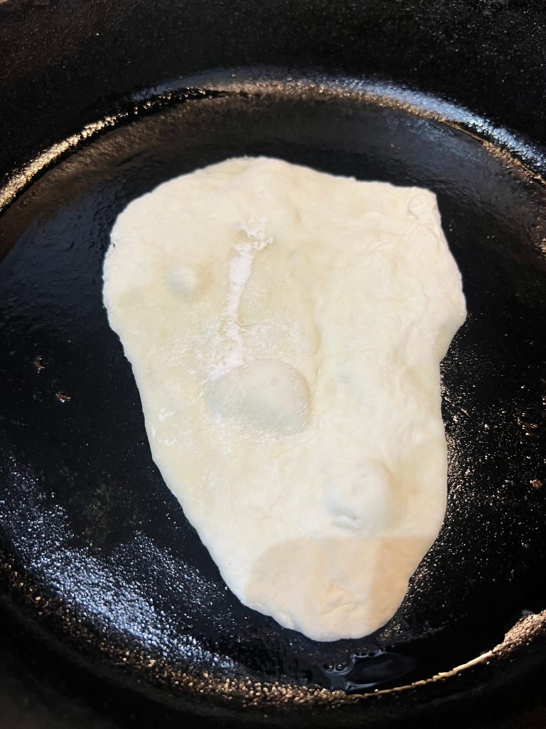 cooking protein naan in cast iron skillet