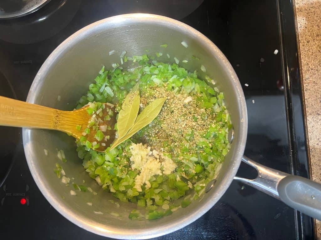 cooking the spices in a stainless steel pot