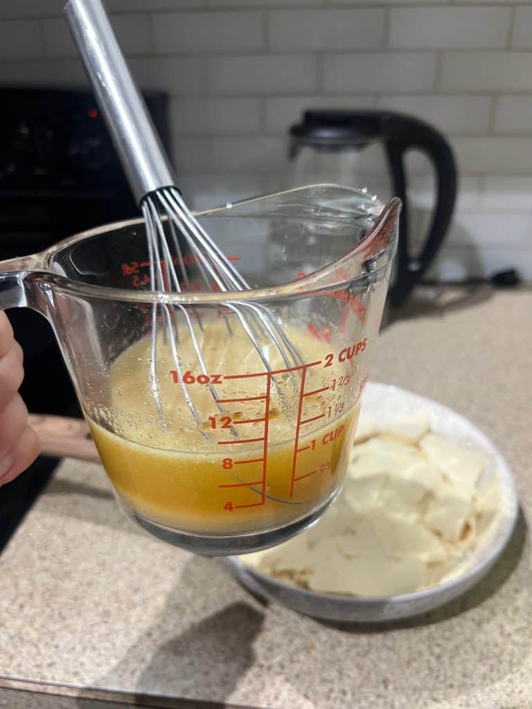 tofu slices marinade in cup measurer