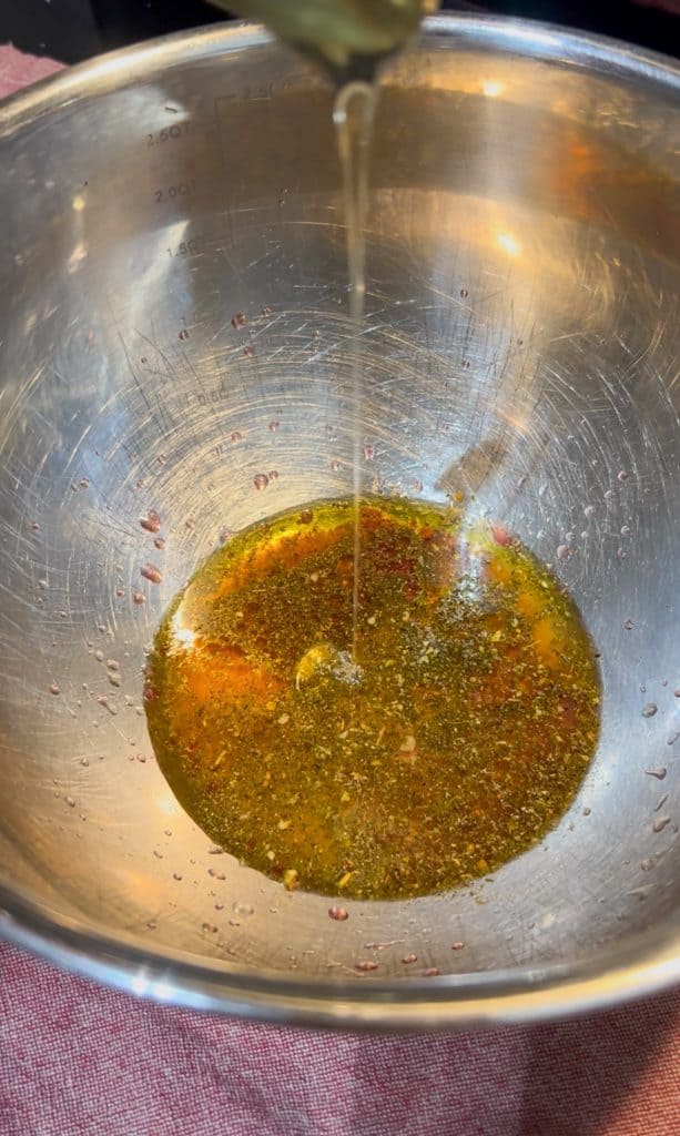 making dressing in bottom of stainless steel bowl