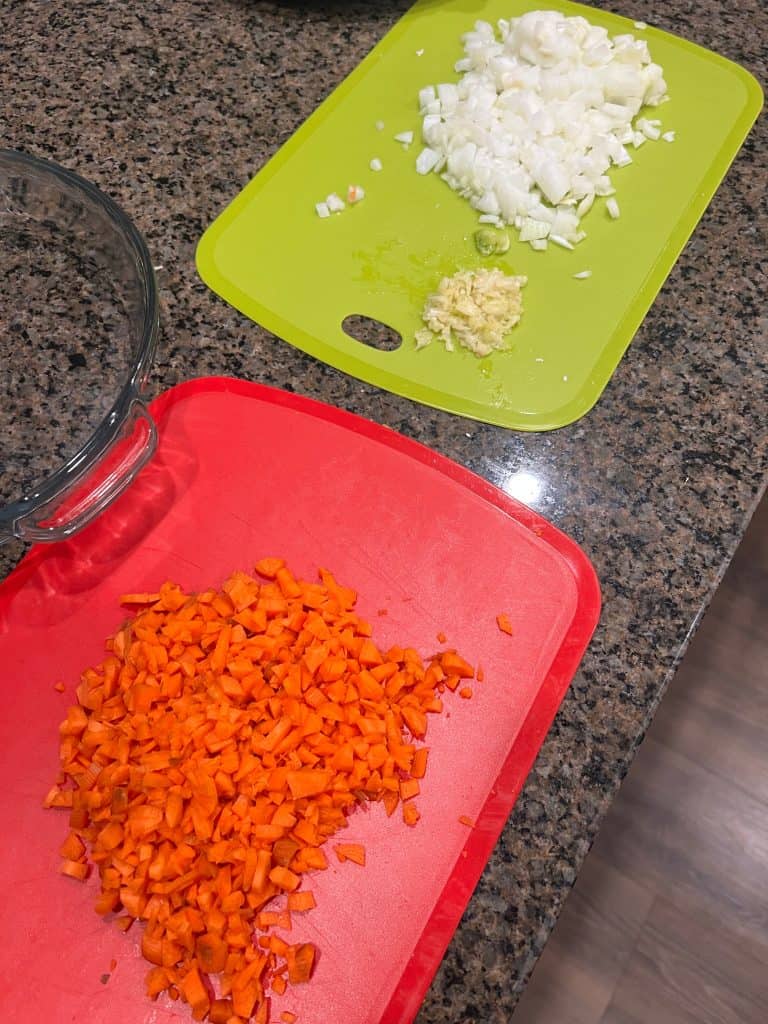 chopped carrot onion cutting board